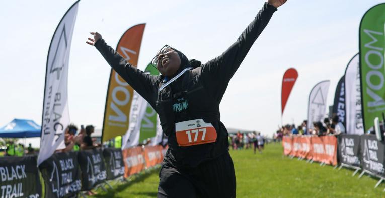 Black To The Trails participant crosses the Finish Line in style