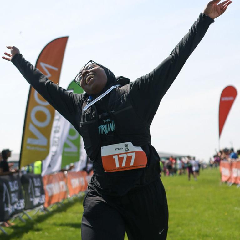 Black To The Trails participant crosses the Finish Line in style