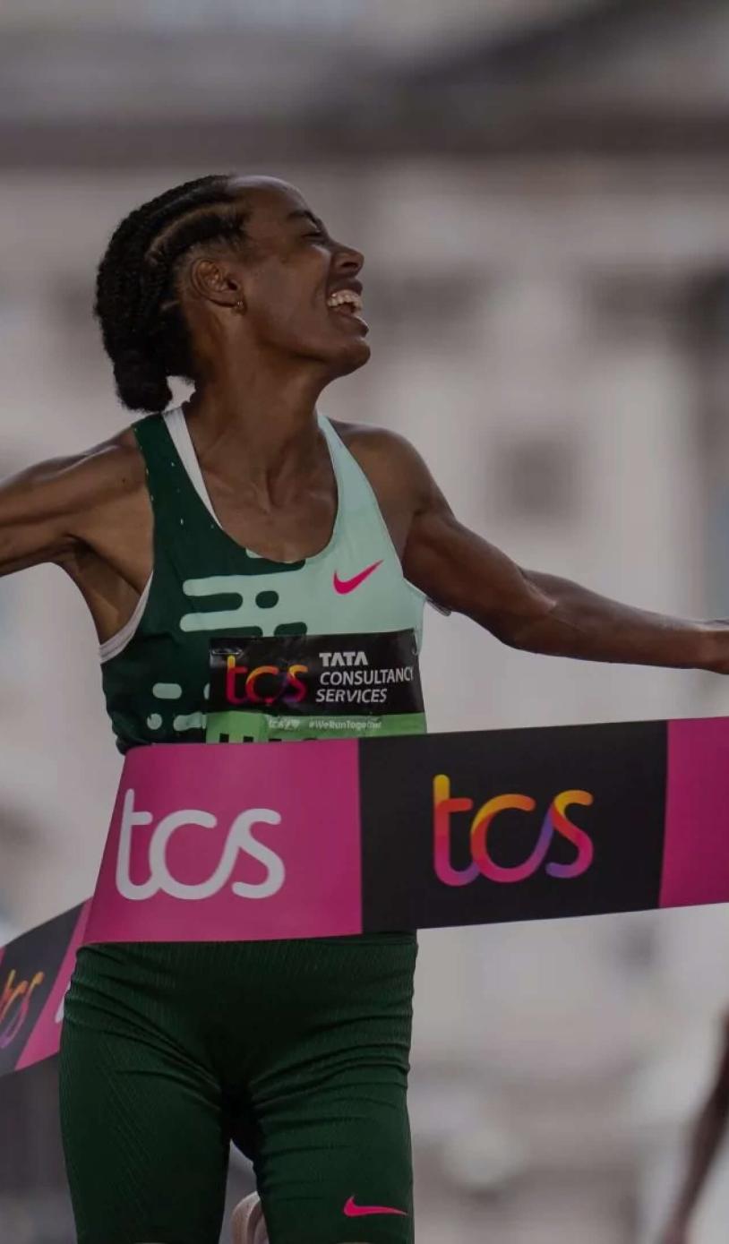 An elite runner crosses the finish line at the TCS London Marathon